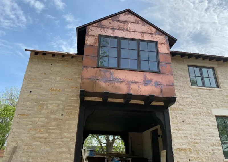 Copper metal panel facade on a stone building for Skylight Installation in East Ridge